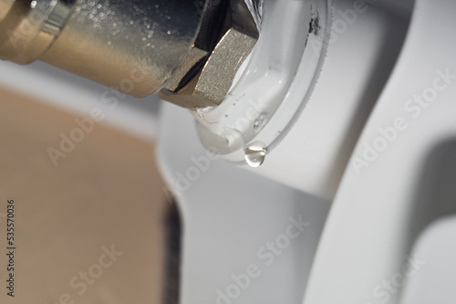 Leakage heating system. Problem with water leakage at the junction of pipes and radiators of the home heating system. Water leakage with poor tightness of threaded pipe connections. Selective focus