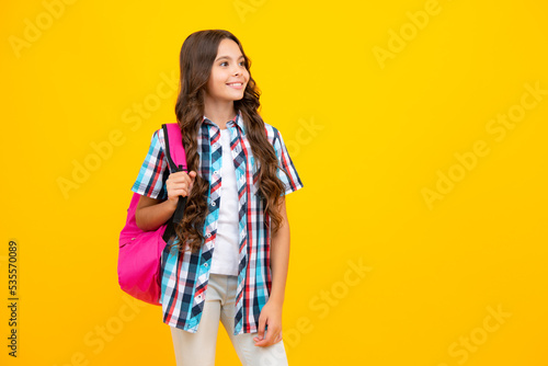 School teen girl in with backpack. Teenager student on isolated background. Kids learning, education, studying and knowledge.