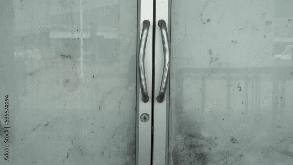 Scary abandoned dirty doors in store or supermarket in city Scary abandoned dirty doors in store or supermarket in city