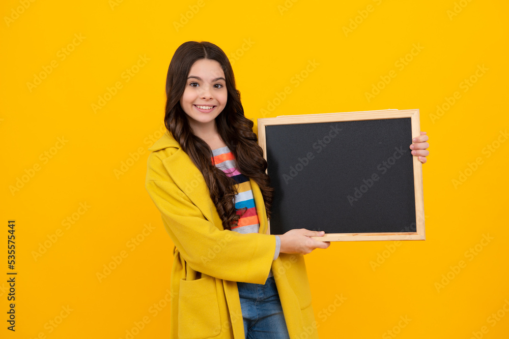 School sales board. Cheerful teenage girl kid hold blackboard chalkboard with copy space. Happy teenager, positive and smiling emotions of teen girl. School sales board. Cheerful teenage girl kid hold blackboard chalkboard with copy space. Happy teenager, positive and smiling emotions of teen girl.