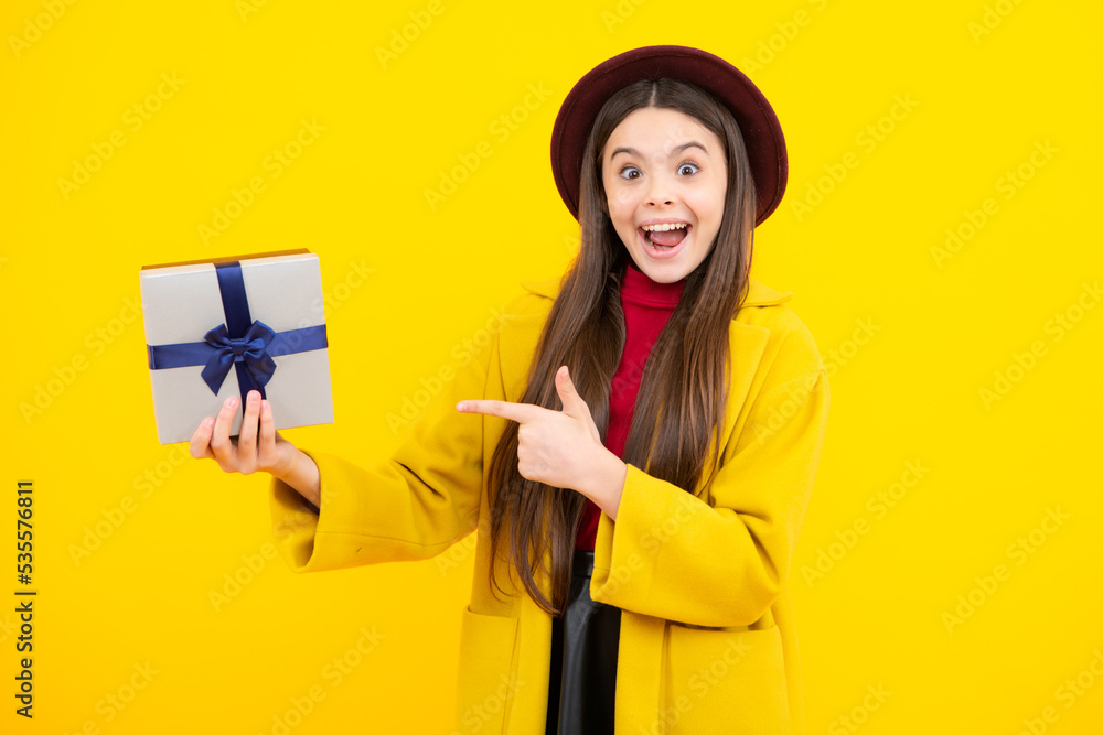 Child with gift present box on isolated studio background. Gifting for kids birthday. Excited teenager, glad amazed and overjoyed emotions. Child with gift present box on isolated studio background. Gifting for kids birthday. Excited teenager, glad amazed and overjoyed emotions.