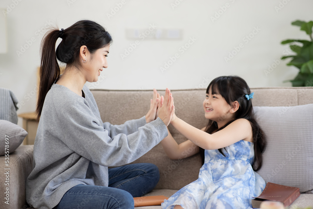 Happy mother and child having fun in living room at home, happy family holiday concept.	