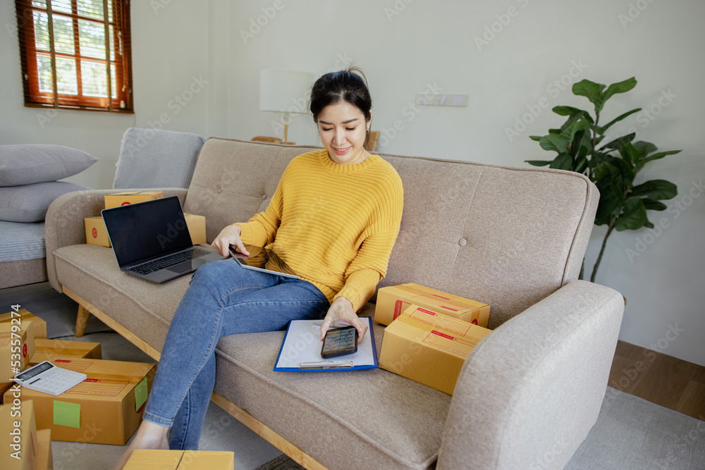 Happy asian young businesswoman using laptop computer online chat with packaging box, Business online influencer on social media concept, Online Selling, Online Shopping to market. Happy asian young businesswoman using laptop computer online chat with packaging box, Business online influencer on social media concept, Online Selling, Online Shopping to market.