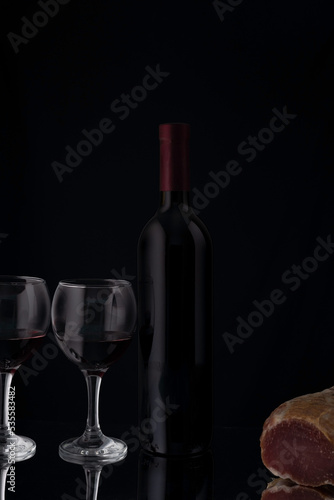 wine still life with jerky on a black background