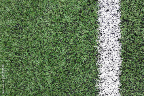 artificial turf with a white stripe close-up. copy space for text