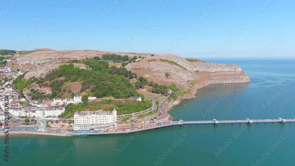 Llandudno, UK: Aerial view of city in Wales, Llandudno Pier Deck Amusement Arcade and waters of Atlantic Ocean in famous summer resort town, sunny day - landscape panorama of United Kingdom from above Llandudno, UK: Aerial view of city in Wales, Llandudno Pier Deck Amusement Arcade and waters of Atlantic Ocean in famous summer resort town, sunny day - landscape panorama of United Kingdom from above