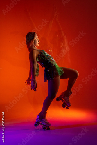 Obraz na płótnie Dancing young mixed race girl enjoying moving in colorful neon studio light