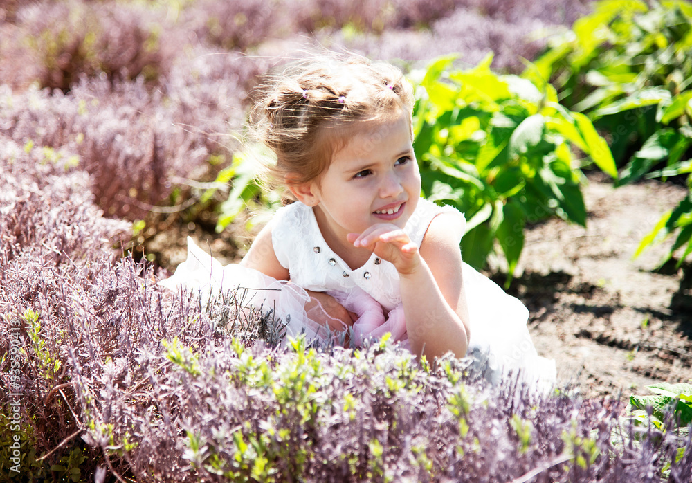 portrait of smiling happy brunette girl in white dress in lavender field in summer  park 