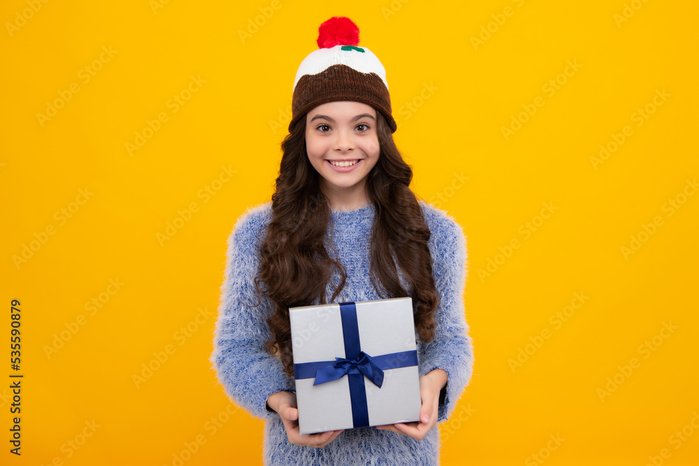 Teenager child with gift box. Present for holidays. Happy birthday, Valentines day, New Year or Christmas. Kid hold present box. Happy teenage girl, positive and smiling emotions. Teenager child with gift box. Present for holidays. Happy birthday, Valentines day, New Year or Christmas. Kid hold present box. Happy teenage girl, positive and smiling emotions.