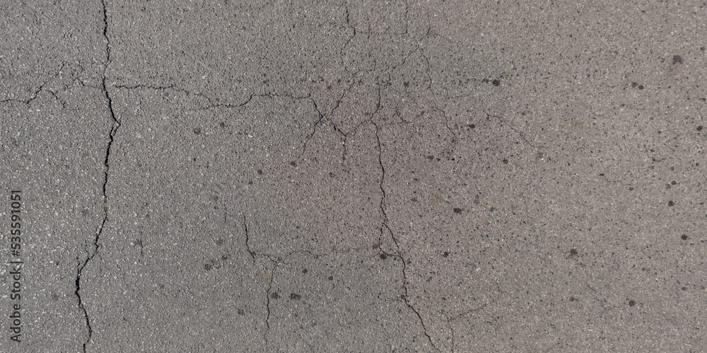 Obraz premium panorama view from above on surface texture of old asphalt road with cracks