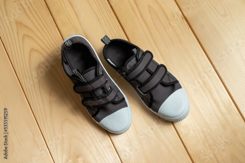 a pair of sneakers on a wooden background.