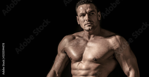 Handsome big muscles man posing at studio. Muscular sexy man. Handsome sexual strong man with muscular body