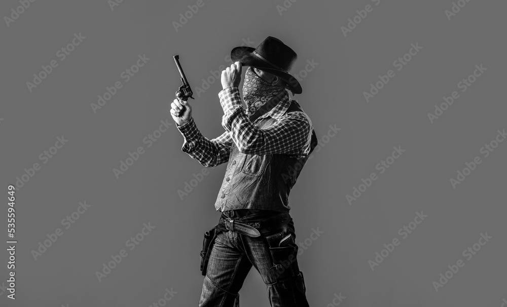 American bandit in mask, western man with hat. Man wearing cowboy hat, gun. West, guns. Black and white American bandit in mask, western man with hat. Man wearing cowboy hat, gun. West, guns. Black and white