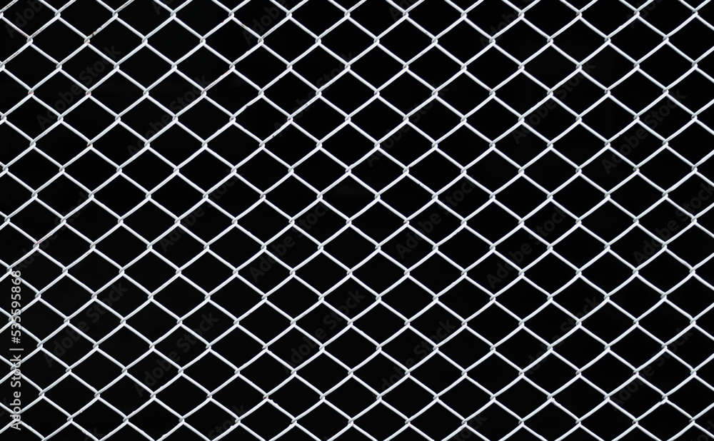 Fototapeta premium Mesh fence background. Grid iron grates, Grid pattern, steel wire mesh fence wall background, Chain link metal seamless pattern fence on black background. 