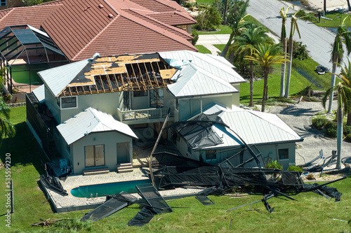 Hurricane Ian destroyed house in Florida residential area. Natural disaster and its consequences photo