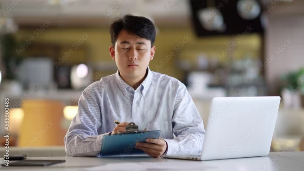young businessman works with laptop in office young businessman works with laptop in office