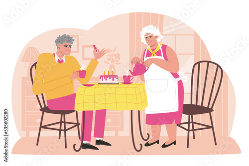 Elderly parents drink tea with cake in a cozy home