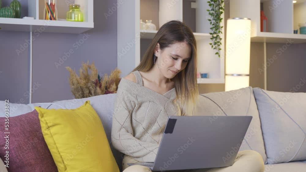 Woman working with laptop.
Young woman sitting on sofa at home working with laptop.
Woman working with laptop.
Young woman sitting on sofa at home working with laptop.