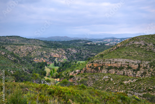 Green Spanish nature landscape. Small path in a valley. Travel and hiking. Blue sky. 