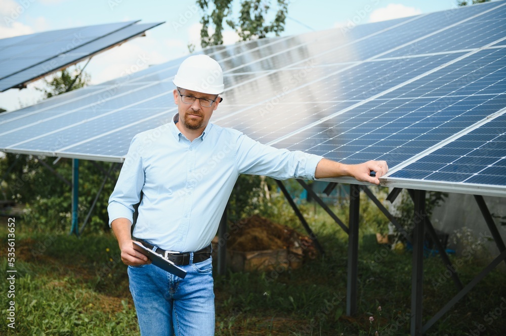 Engineer at solar power station with solar panel. Practical lessons on renewable energy power plants. Engineer at solar power station with solar panel. Practical lessons on renewable energy power plants.