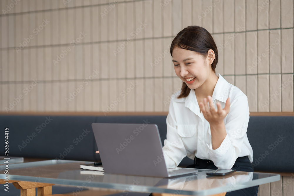 Beautiful Asian businesswoman is video chatting with customer using laptop in office and negotiating gestures smiling and happy face. Beautiful Asian businesswoman is video chatting with customer using laptop in office and negotiating gestures smiling and happy face.