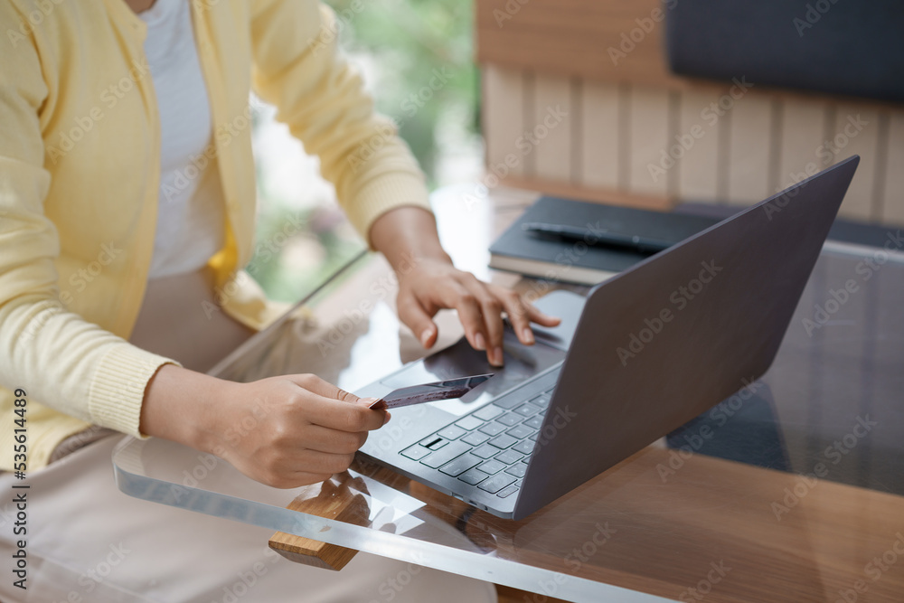 Close-up of woman using laptop and credit card for online shopping. Online payment. Close-up of woman using laptop and credit card for online shopping. Online payment.