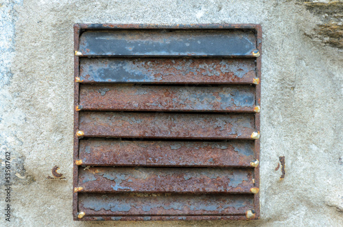 Old rusted external ventilation louvres on fasade of house