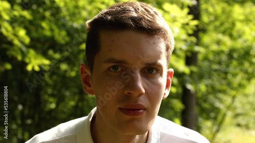 Young man face on a green nature background. Pavel Kubarkov, my face on a green natural background. Date of shooting day 13 July 2022 year, MSK time. This video was filmed in Russia.