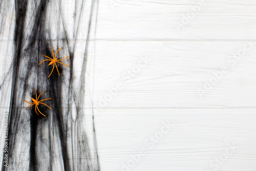 halloween background. black cobweb with spiders on white wooden background photo