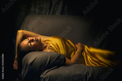 woman with yellow dress lying in a chair III