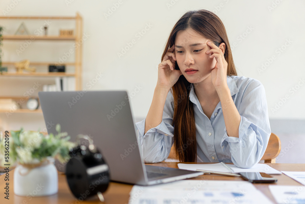 Female freelance is feeling stressful and headache from thinking the strategy plan of the business Female freelance is feeling stressful and headache from thinking the strategy plan of the business