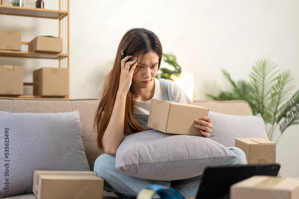 Young entrepreneur is feeling stressful during checking online orders and customer data on tablet