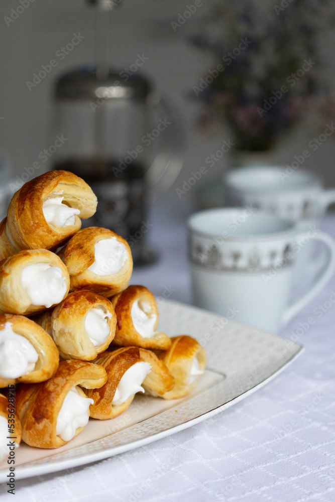 Homemade puff pastry cones stuffed with egg white cream Homemade puff pastry cones stuffed with egg white cream