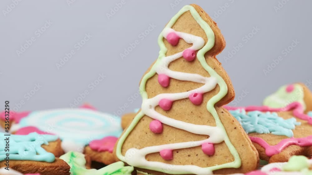 Decorated Christmas tree gingerbread with green and white frosting icing cream toppings and pink beads. Christmas gingerbreads for celebration Decorated Christmas tree gingerbread with green and white frosting icing cream toppings and pink beads. Christmas gingerbreads for celebration