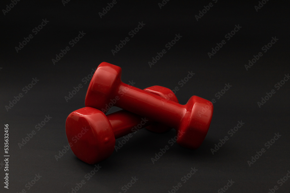 Little red weights on a black background Little red weights on a black background