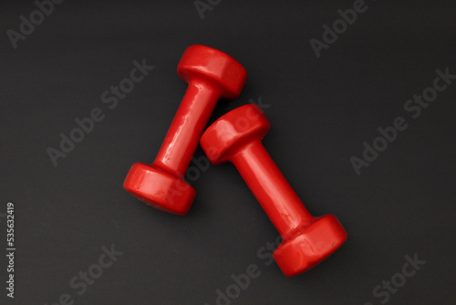 Little red weights on a black background