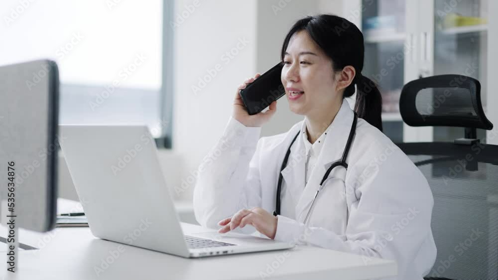 young woman doctor works with mobile phone in clinic young woman doctor works with mobile phone in clinic