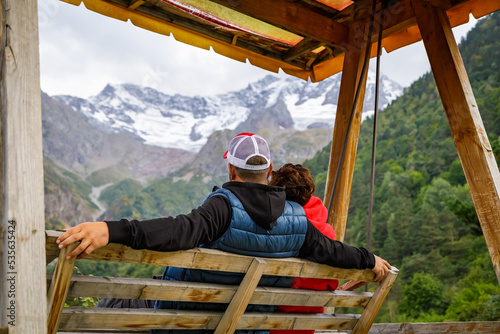 Wallpaper Mural A man and a woman swing on a swing high in the mountains. Relax and enjoy nature Torontodigital.ca