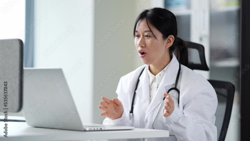 young woman doctor works with laptop in clinic young woman doctor works with laptop in clinic