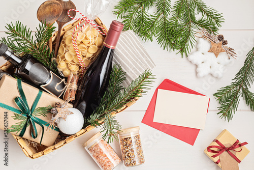 Quadro su tela Refined Christmas gift basket for culinary enthusiats with bottle of wine and italian cusine ingredients