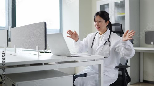 Wallpaper Mural young woman doctor works with laptop in clinic Torontodigital.ca