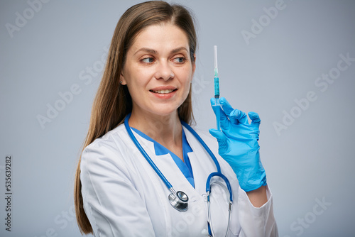 Doctor in blue gloves holding syringe with vaccine. Isolated portrait.