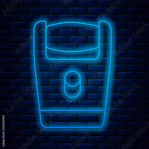 Glowing neon line Electric razor blade for men icon isolated on brick wall background. Electric shaver. Vector