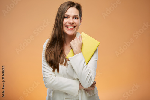 Student or teacher woman with yellow book on orange background isolated female portrait.