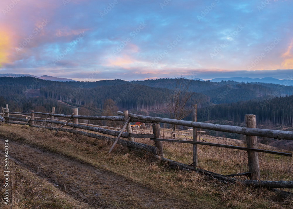 Picturesque pre sunrise morning above late autumn mountain countryside. Ukraine, Carpathian Mountains, Petros top in far. Peaceful traveling, seasonal, nature and countryside beauty concept scene.