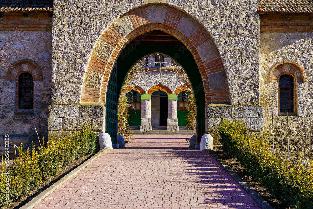 Fototapeta premium Stone arch at the entrance to the old stone church. Background with selective focus and copy space