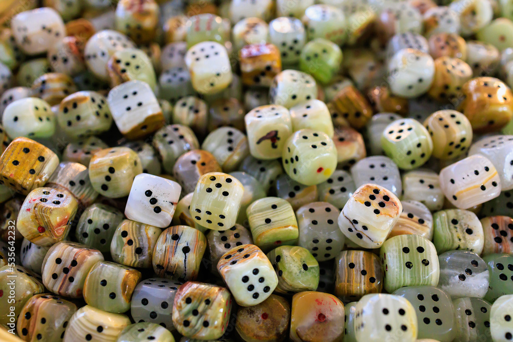 Dice made of natural stone. Background with selective focus and copy space