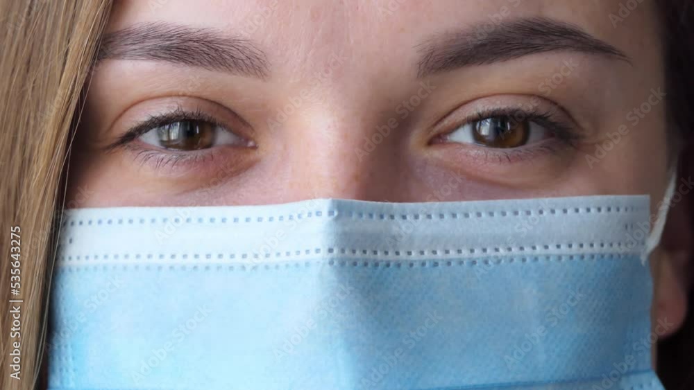 Portrait of beautiful young woman female doctor wearing medical face mask indoors. Medicine, people and infectious diseases concept. Portrait of beautiful young woman female doctor wearing medical face mask indoors. Medicine, people and infectious diseases concept.