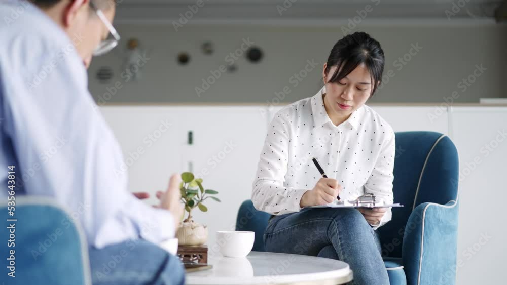 young woman doctor and midaged man in meeting room young woman doctor and midaged man in meeting room