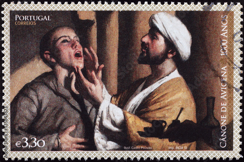 Canon of Medicine by Avicenna on portuguese postage stamp photo